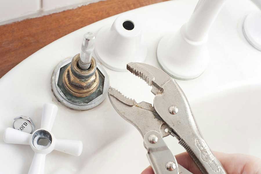 Adjusting faucet valve during sink installation in Lake Oswego