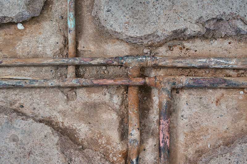 Exposed pipes during slab leak repair work in Lake Oswego